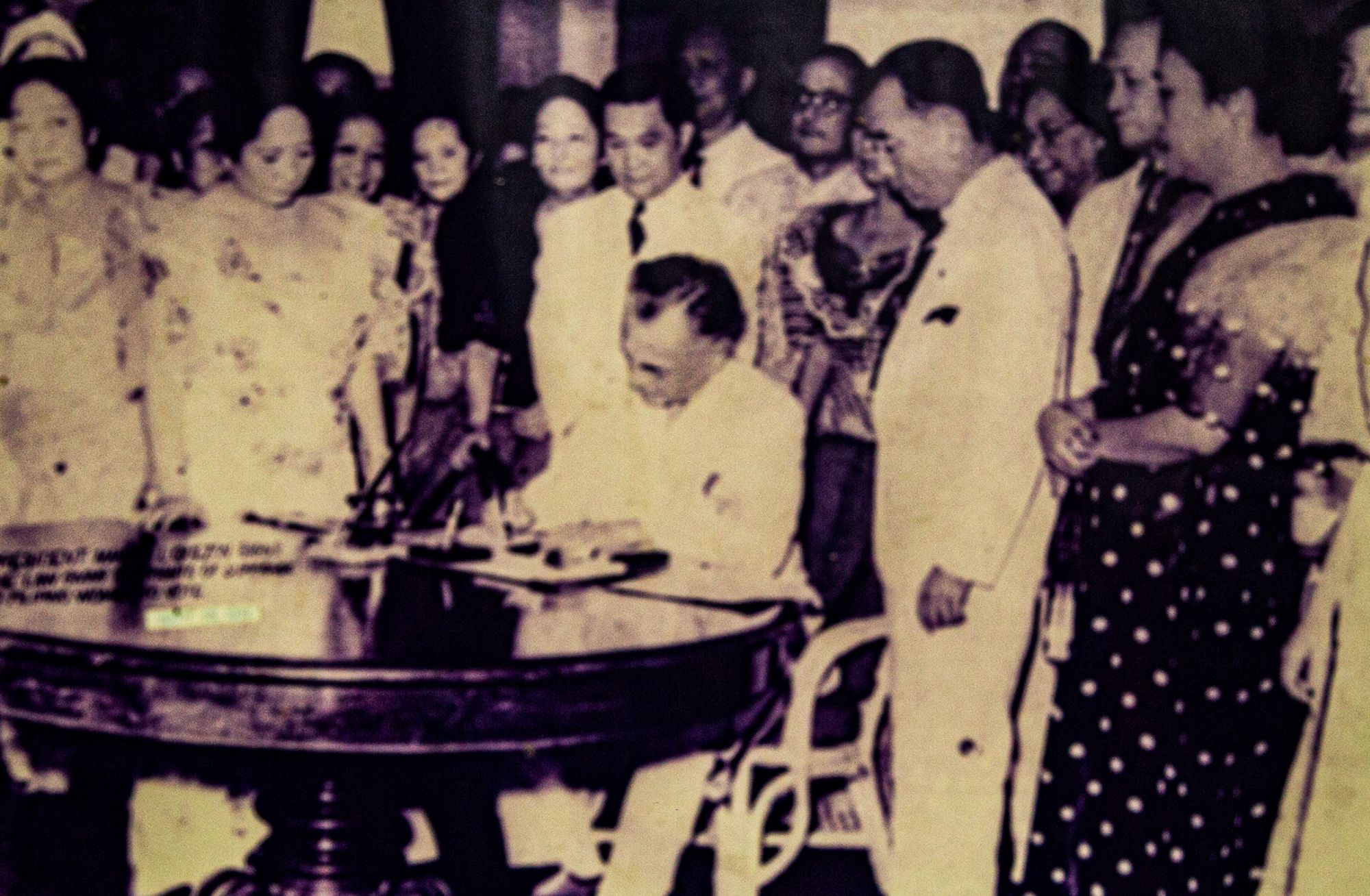President Manuel L. Quezon signing the Women's Suffrage Law in 1937 in the presence of NFWC officers